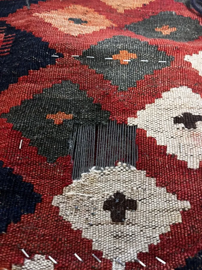 Kilim rug mid-restoration — structural repair in progress